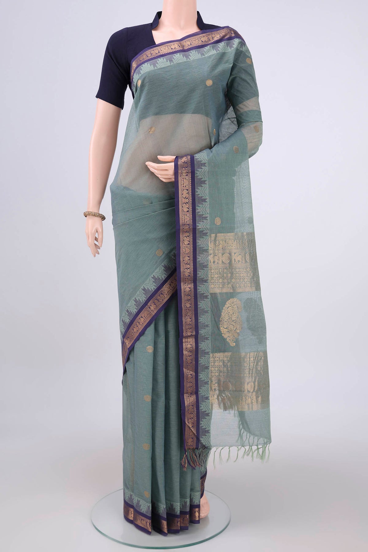 Davys Grey Kanchi Cotton Saree with Zari Butta on the body and Zari Border.  displayed on a mannequin