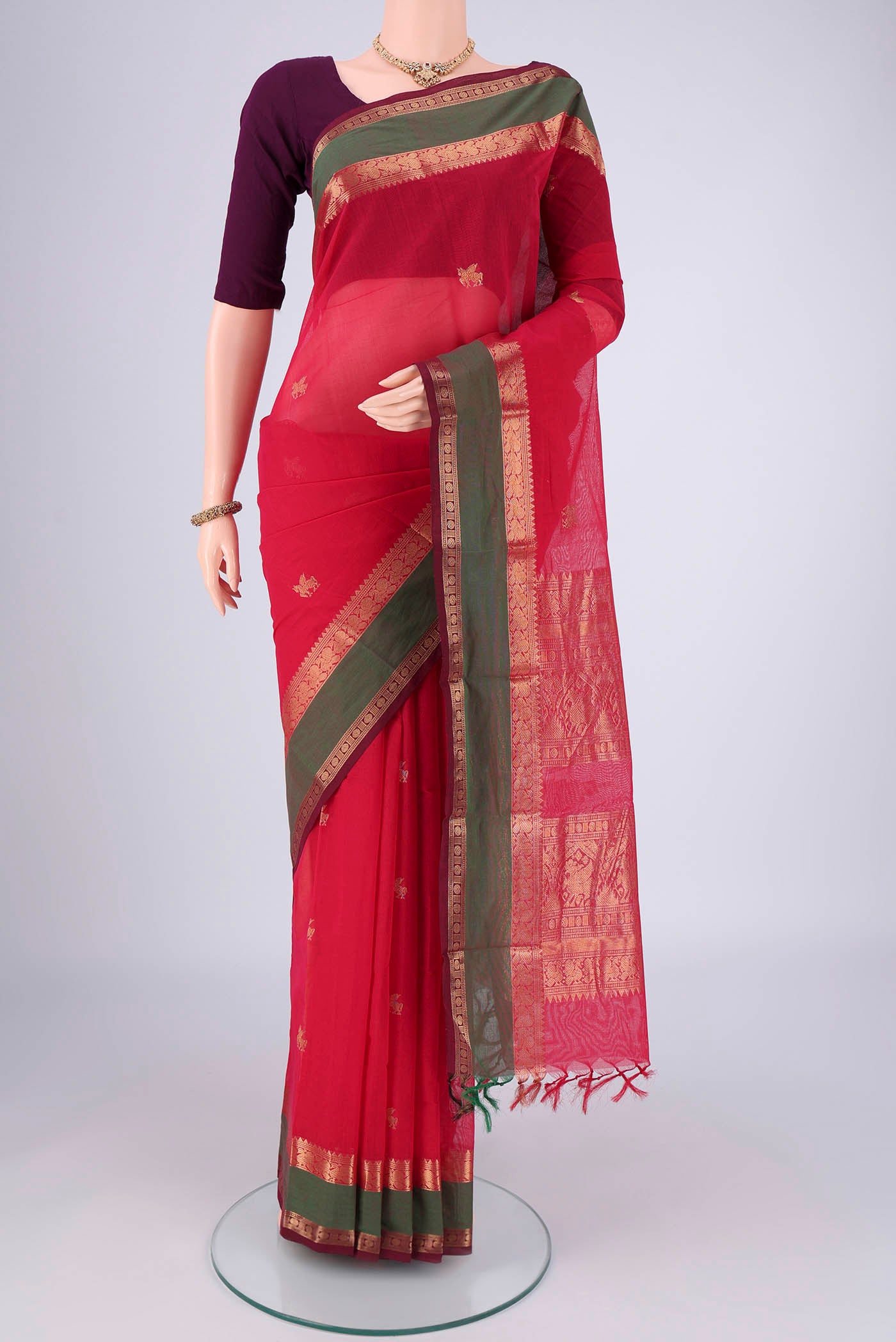 Red Kanchi Cotton Saree with Plain Body and Zari Border.  displayed on a mannequin