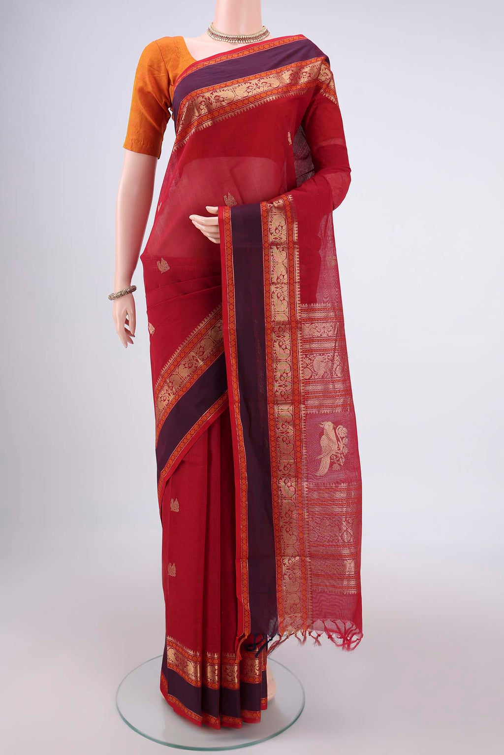 Red Kanchi Cotton Saree with Zari Butta on the body and Zari Border.  displayed on a mannequin