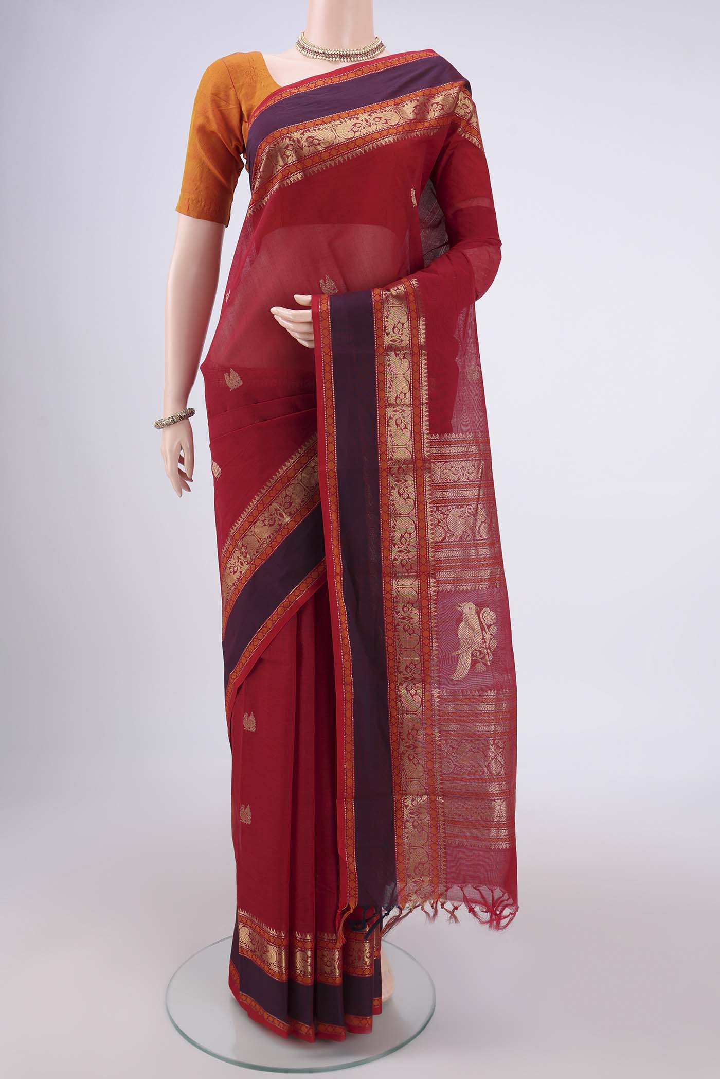 Red Kanchi Cotton Saree with Zari Butta on the body and Zari Border.  displayed on a mannequin