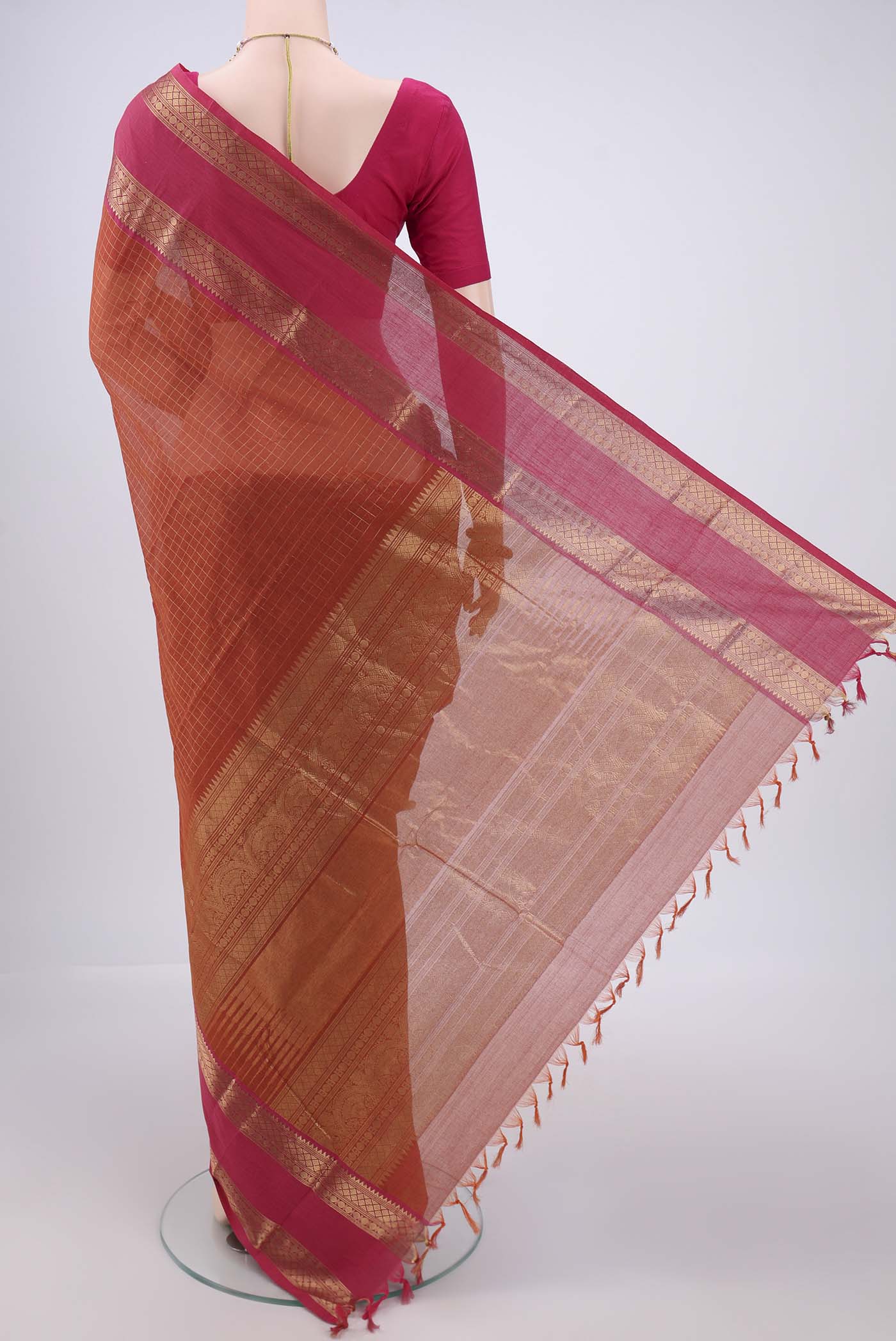 Flat view of Rust Kanchi Cotton Saree with Checked design on the body and Zari Border. 