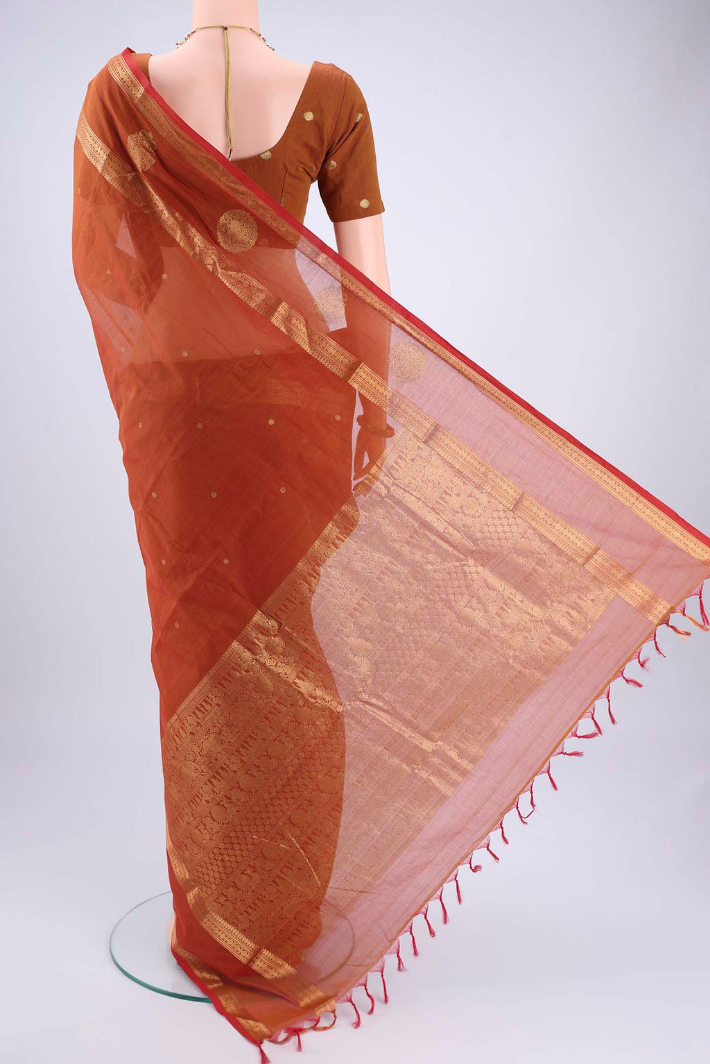 Flat view of Rust Kanchi Cotton Saree with Plain Body and Zari Border. 