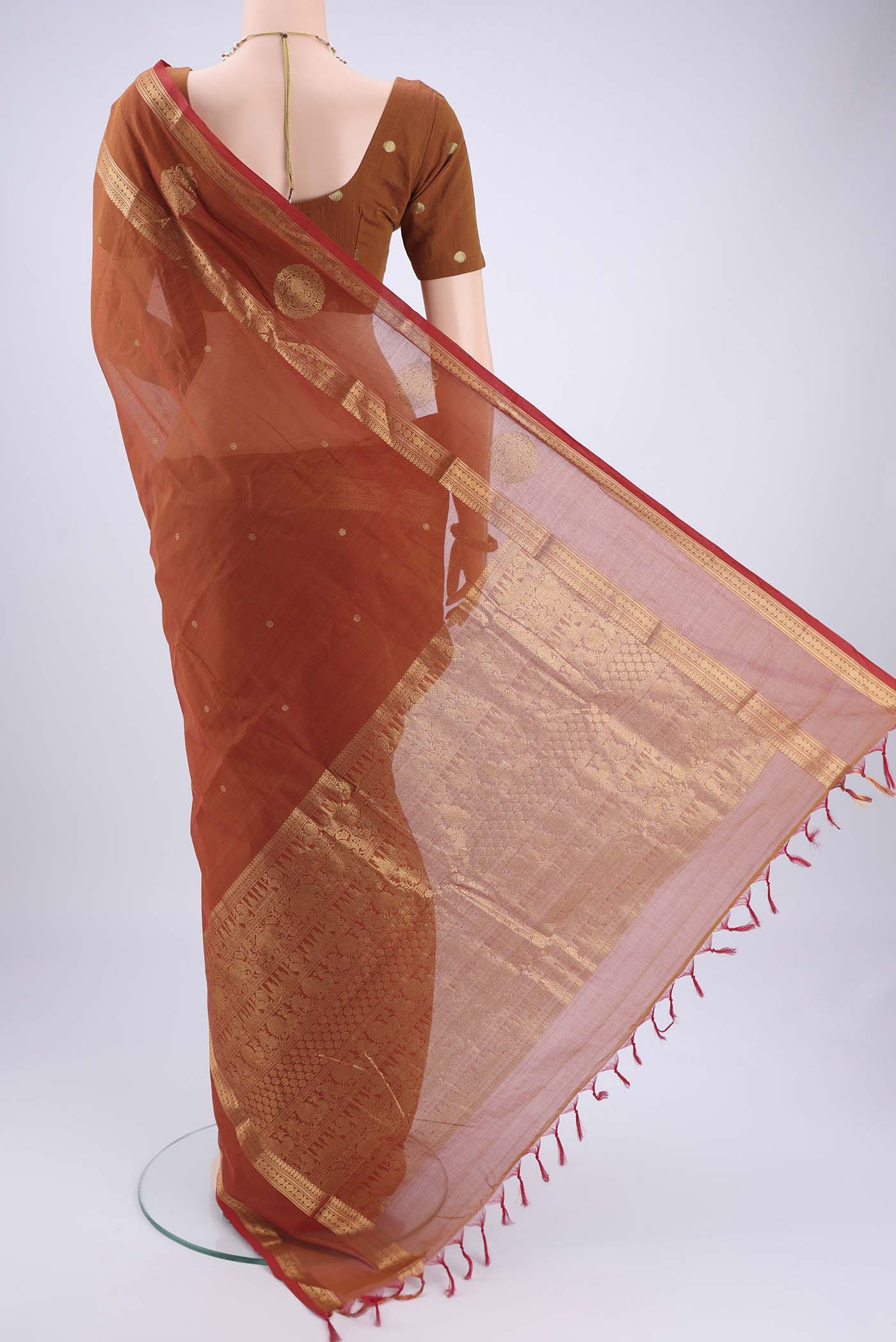 Flat view of Rust Kanchi Cotton Saree with Plain Body and Zari Border. 