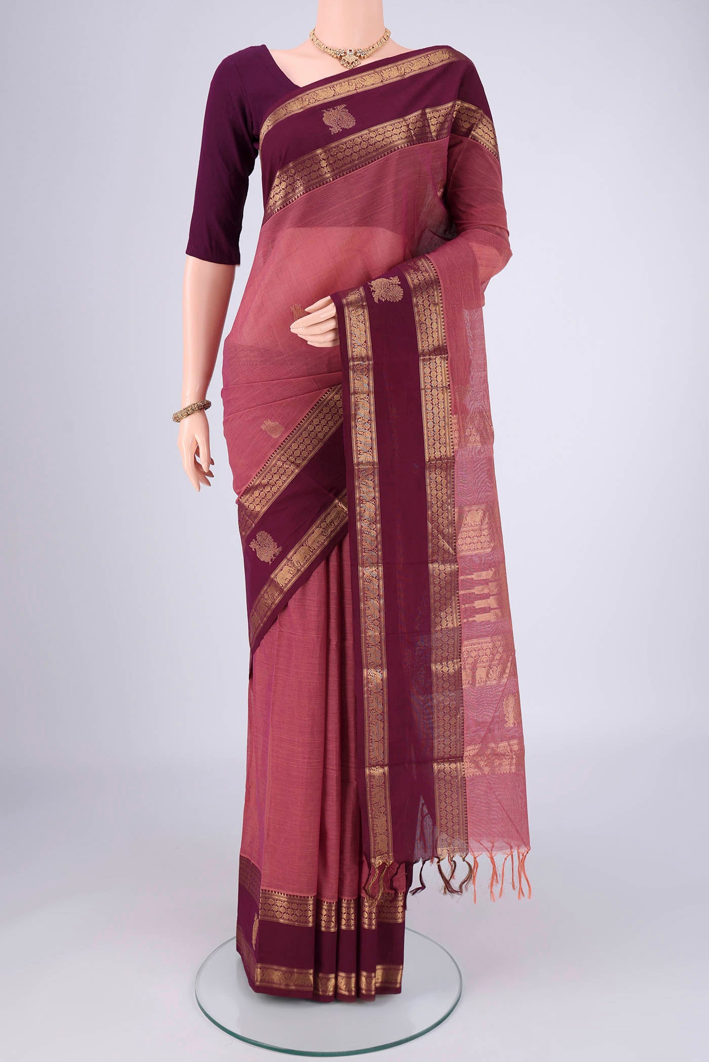 Dark Mauve Kanchi Cotton Saree with Plain Body and Zari Border.  displayed on a mannequin