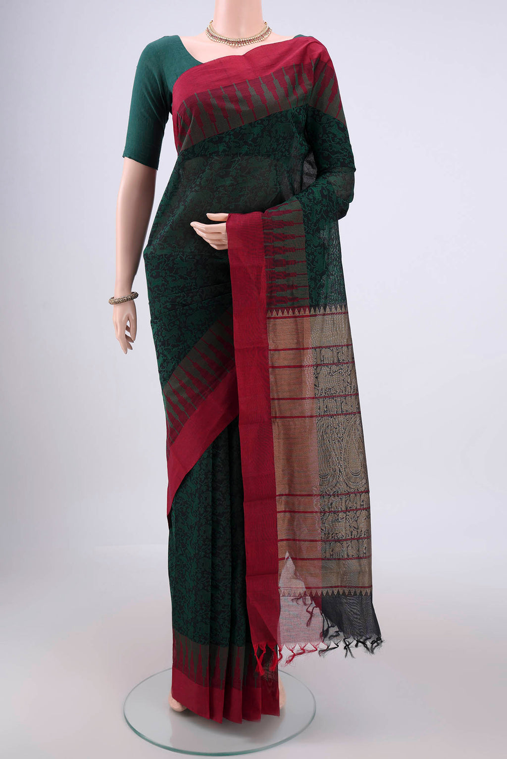 Bottle Green Kanchi Cotton Saree with Jacquard design on the body and Thread Border.  displayed on a mannequin