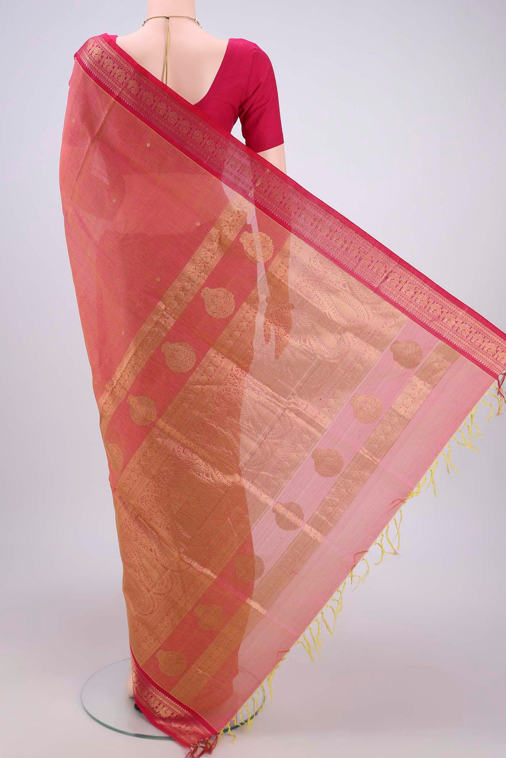 Flat view of Peach Kanjivaram Saree with Zari Butta on the body and Zari Border. 