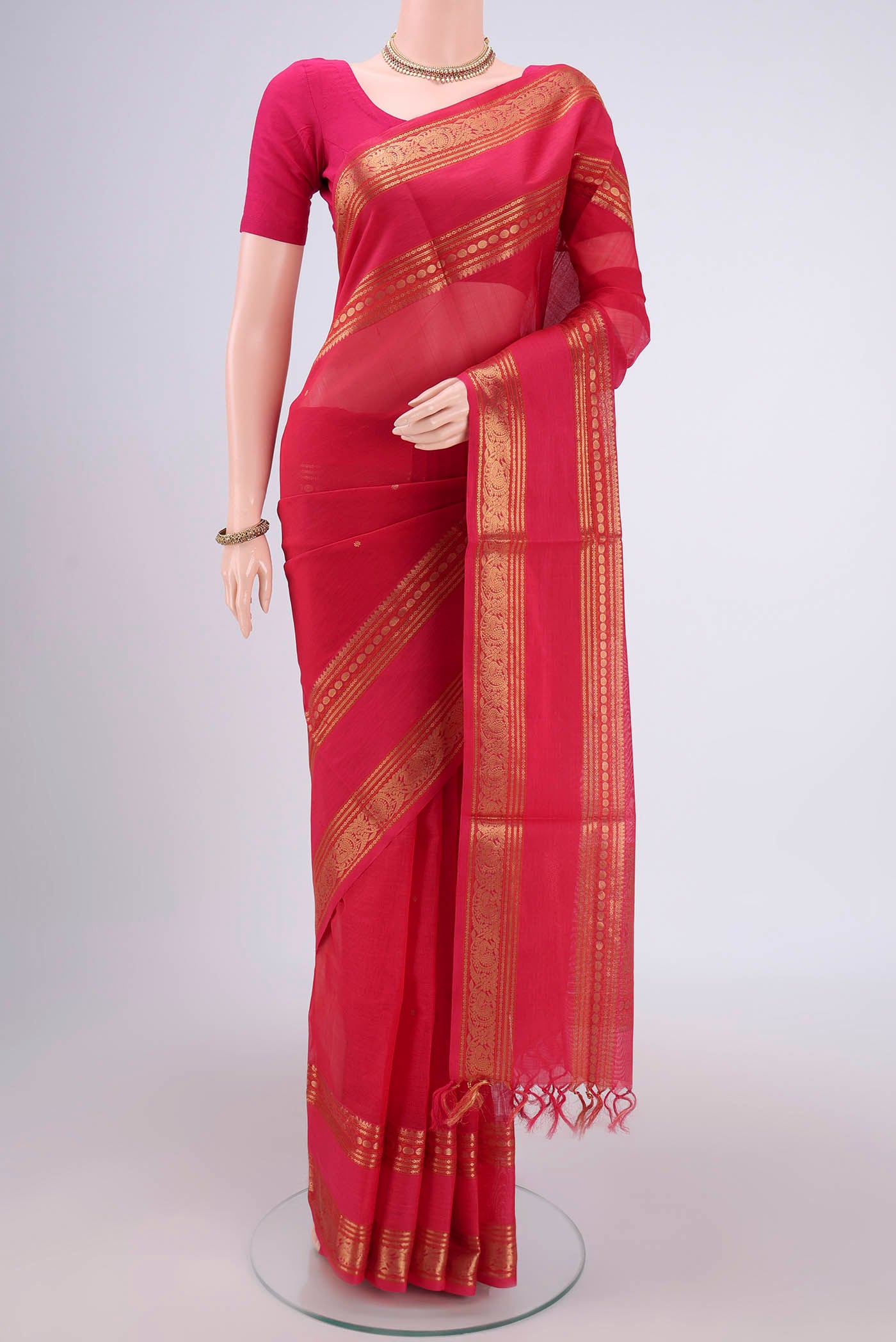 Dark Pink Kanjivaram Saree with Zari Butta on the body and Zari Border.  displayed on a mannequin
