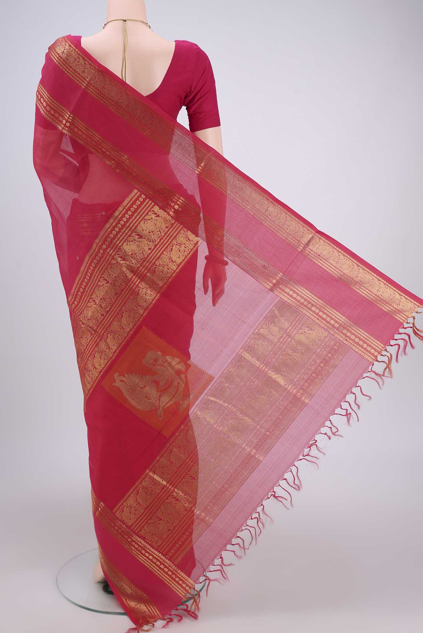 Flat view of Dark Pink Kanjivaram Saree with Zari Butta on the body and Zari Border. 