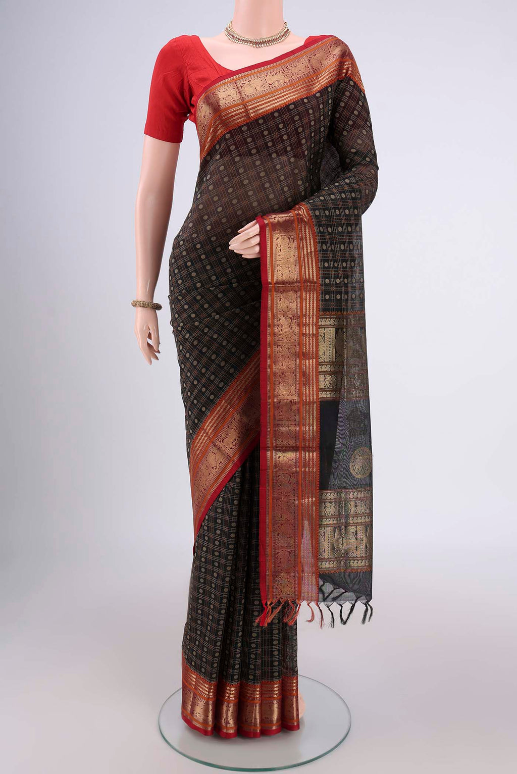 Black Kanjivaram Saree with Checked design on the body and Zari Border.  displayed on a mannequin