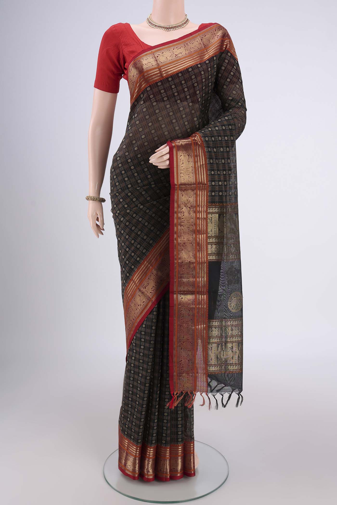 Black Kanjivaram Saree with Checked design on the body and Zari Border.  displayed on a mannequin