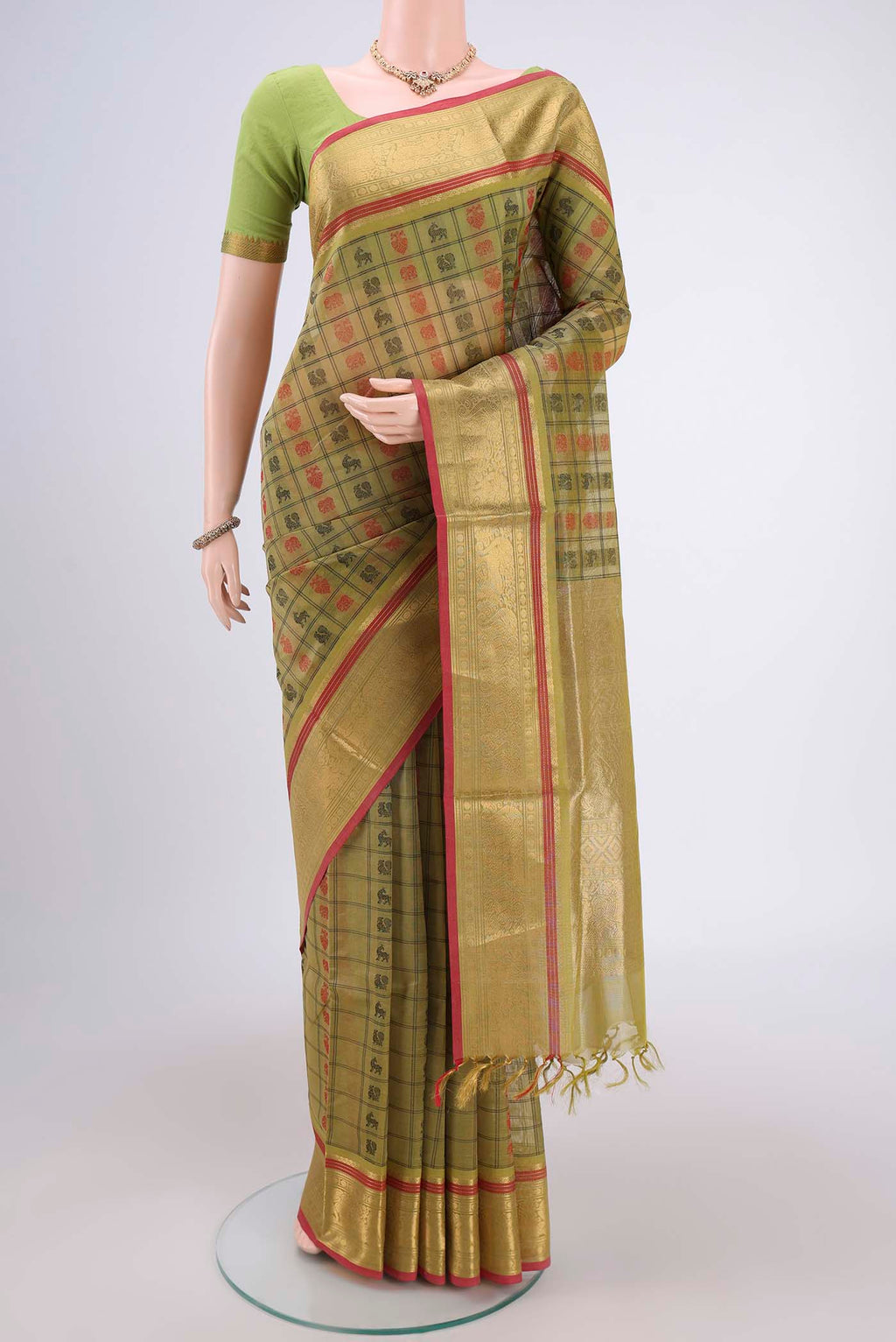 Light Green Kanjivaram Saree with Checked design on the body and Zari Border.  displayed on a mannequin