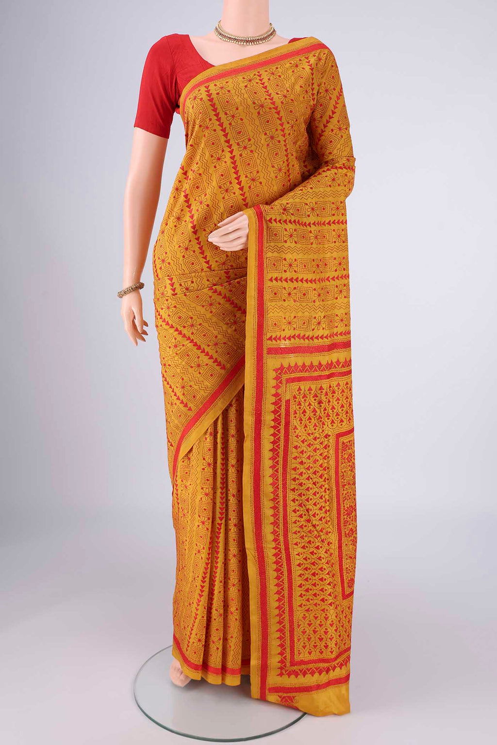 Mustard Kantha Silk Saree with Kantha Work on the body and Thread Border.  displayed on a mannequin