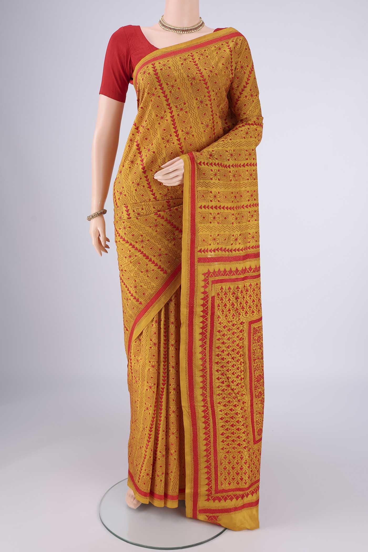 Mustard Kantha Silk Saree with Kantha Work on the body and Thread Border.  displayed on a mannequin