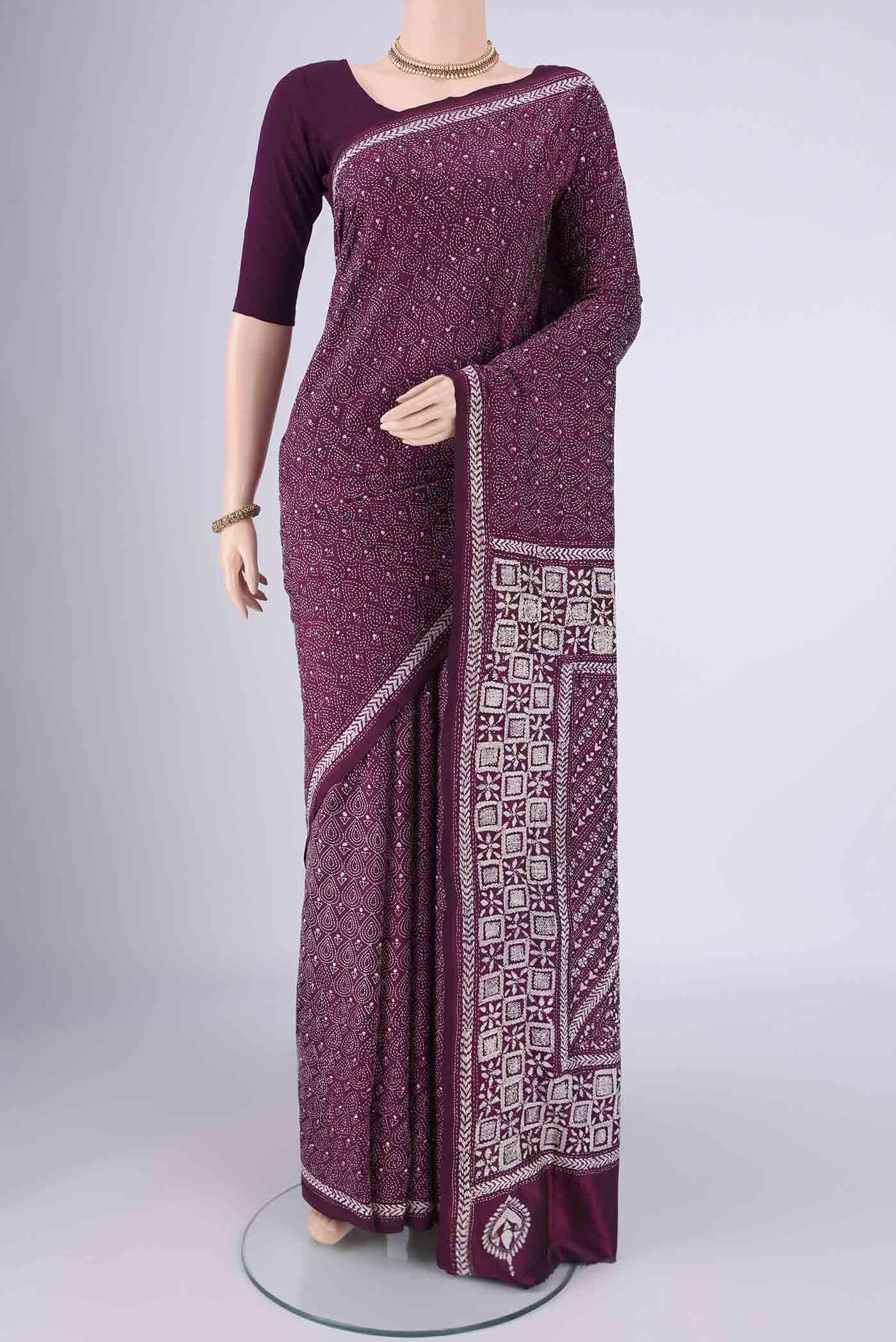 Magenta Kantha Silk Saree with Kantha Work on the body and Thread Border.  displayed on a mannequin