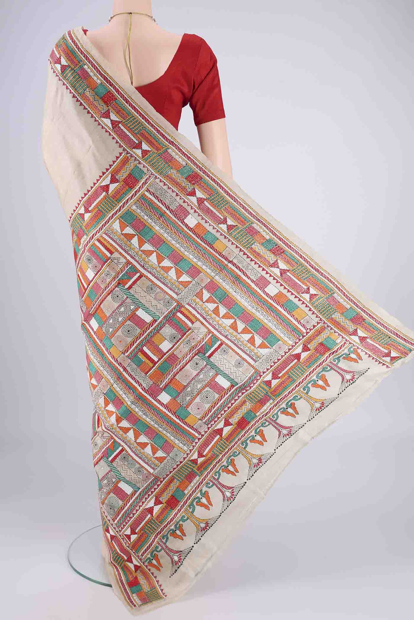 Flat view of Beige Tussar Silk Saree with Kantha Work on the body and Thread Border. 