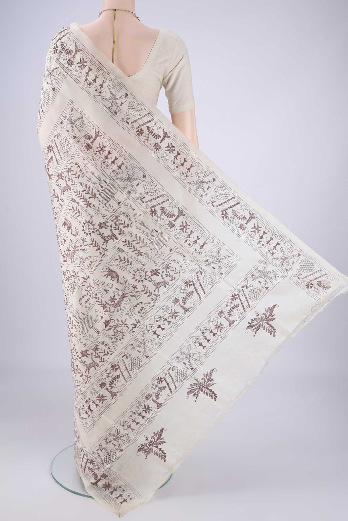 Flat view of Beige Tussar Silk Saree with Kantha Work on the body and Thread Border. 