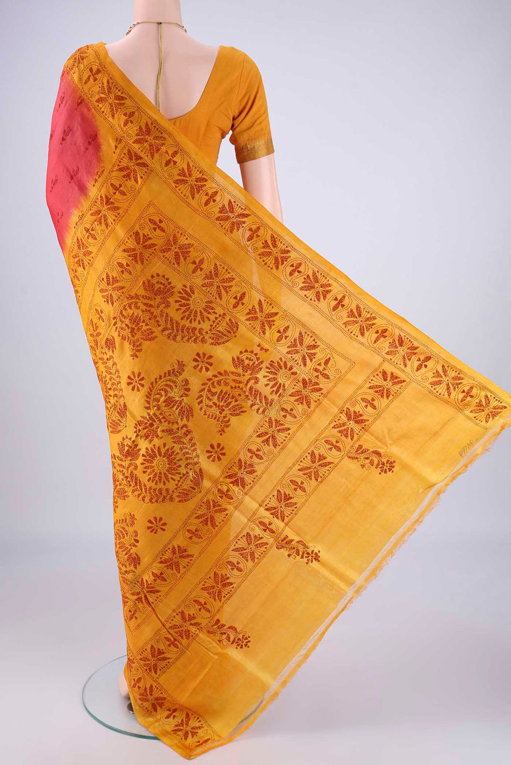 Flat view of Coral Tussar Silk Saree with Kantha Work on the body and Thread Border. 
