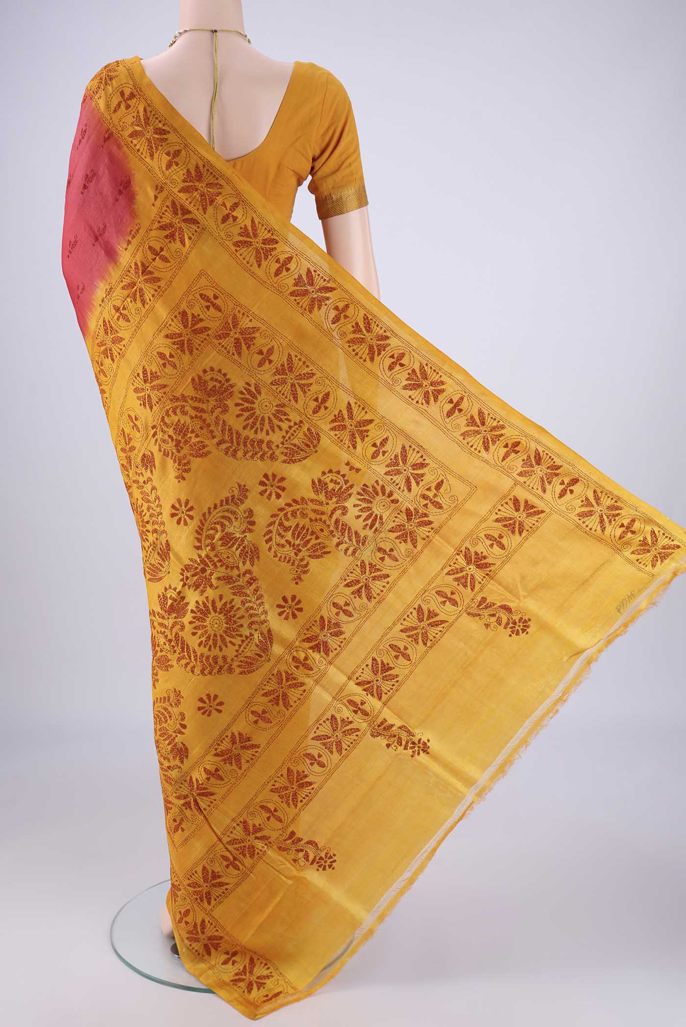Flat view of Coral Tussar Silk Saree with Kantha Work on the body and Thread Border. 
