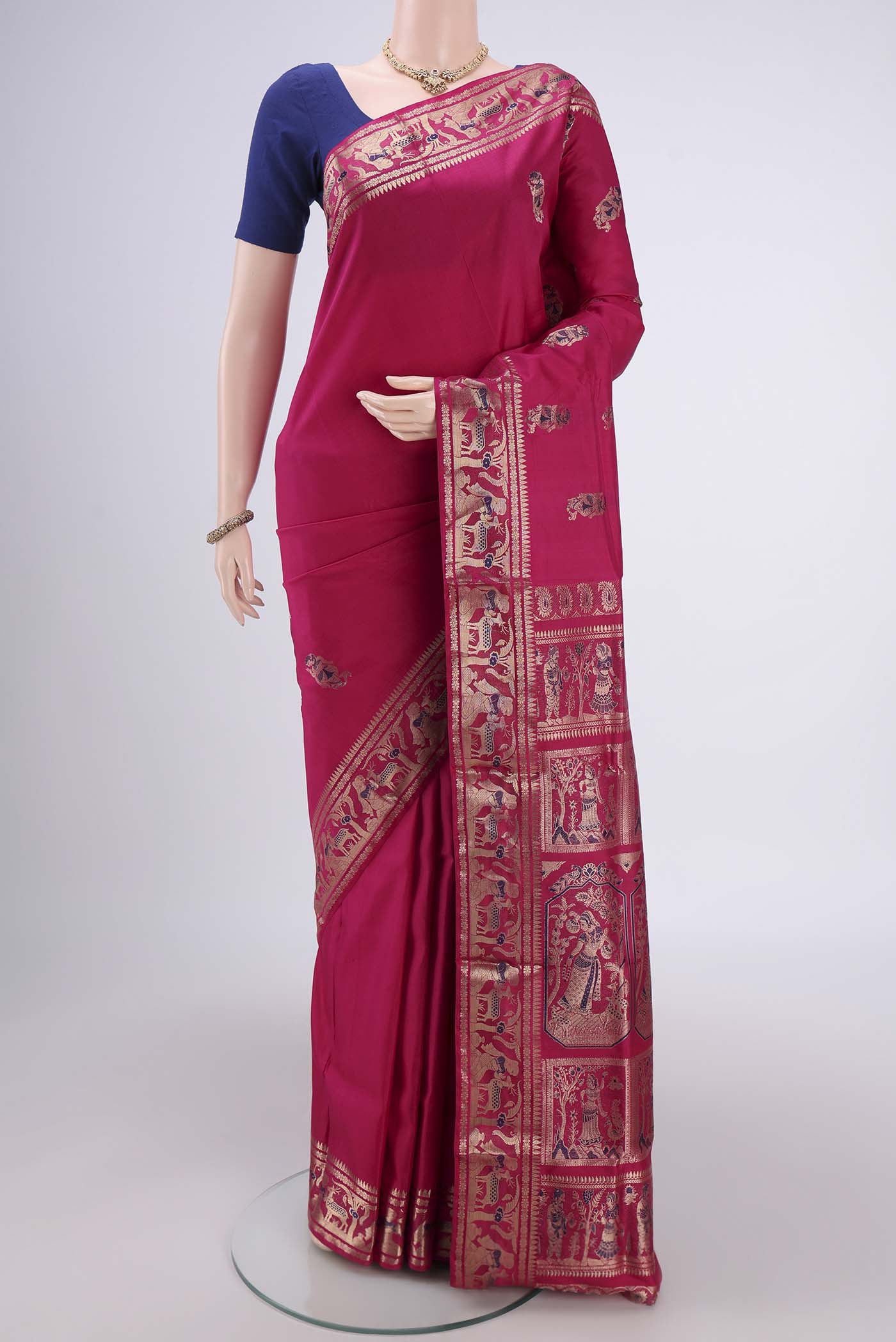 Rani Pink Baluchari Silk Saree with Zari And Thread Butta on the body and Zari And Thread Border.  displayed on a mannequin