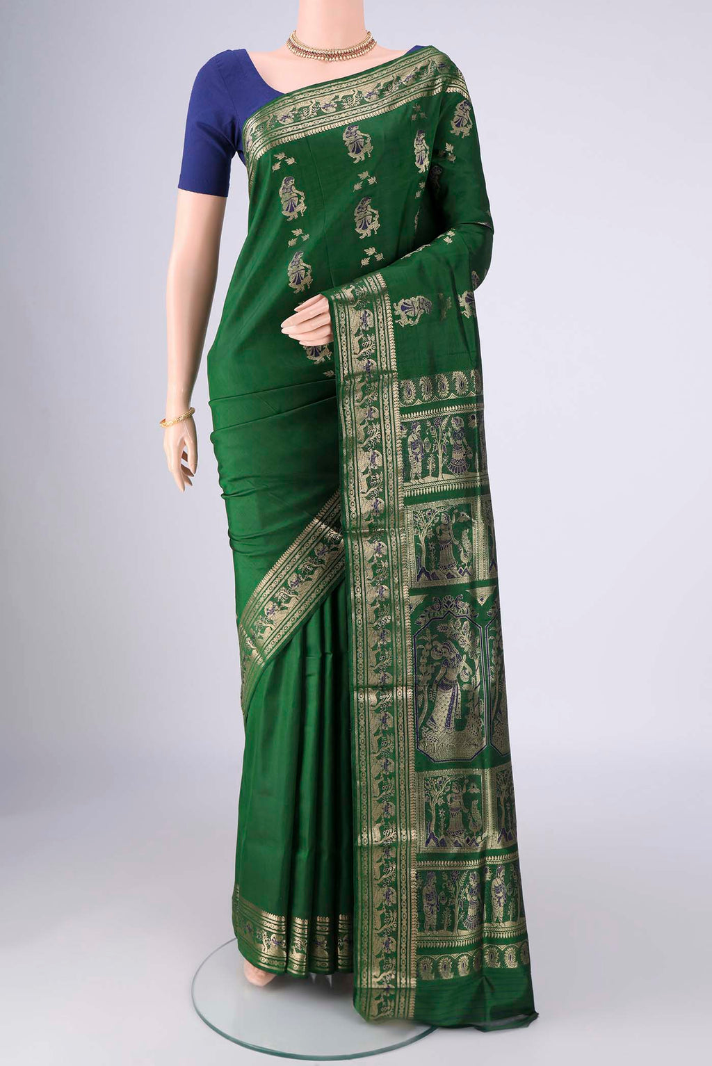 Bottle Green Baluchari Silk Saree with Zari And Thread Butta on the body and Zari And Thread Border.  displayed on a mannequin