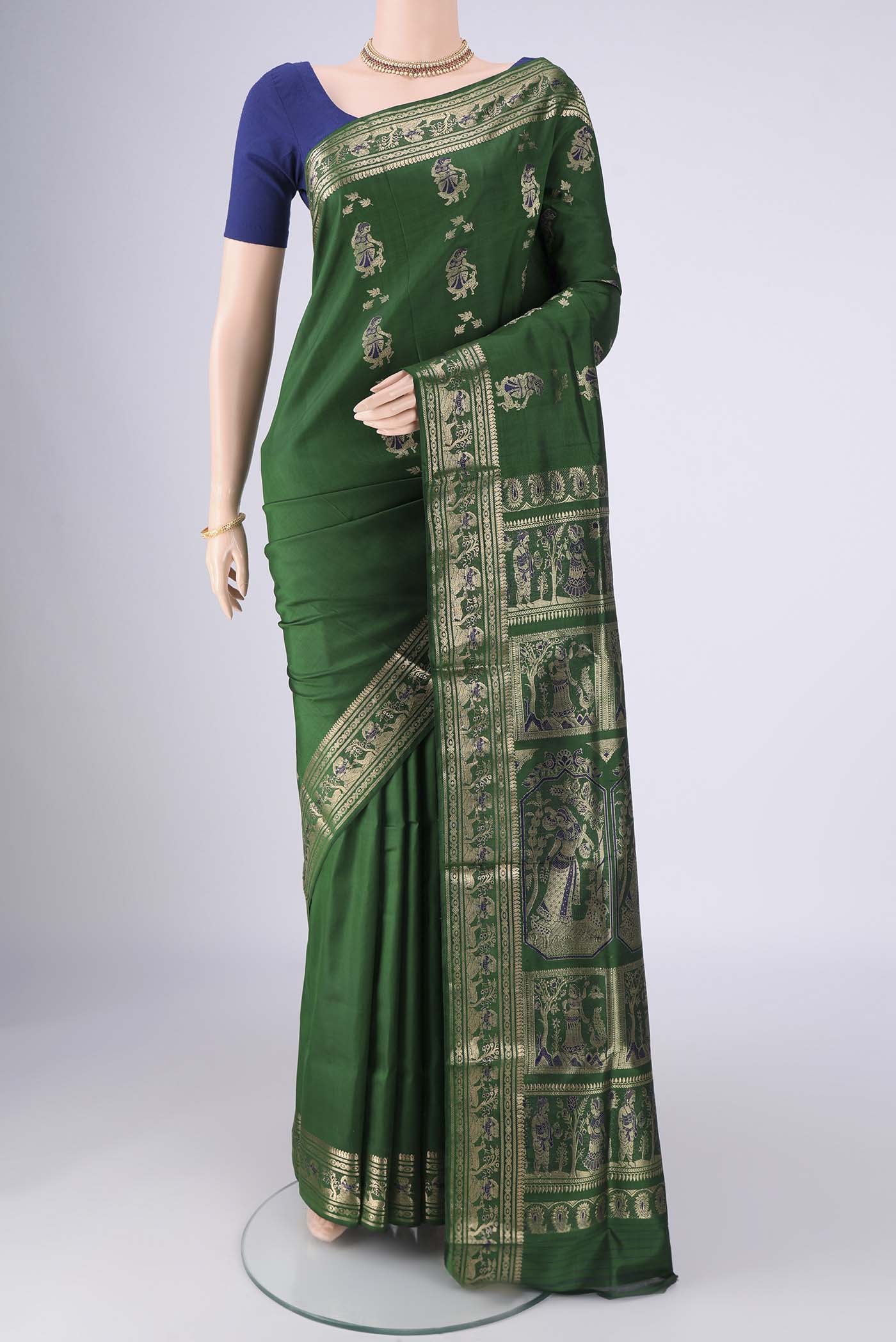 Bottle Green Baluchari Silk Saree with Zari And Thread Butta on the body and Zari And Thread Border.  displayed on a mannequin