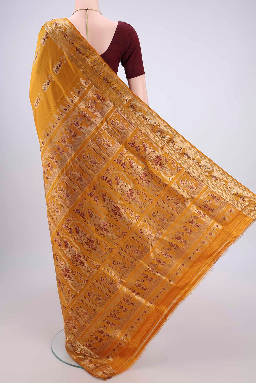 Flat view of Mustard Baluchari Silk Saree with Zari And Thread Butta on the body and Zari And Thread Border. 