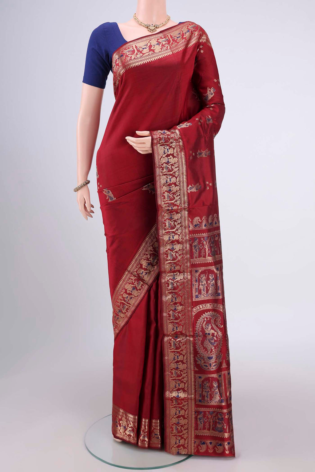 Maroon Baluchari Silk Saree with Zari And Thread Butta on the body and Zari And Thread Border.  displayed on a mannequin