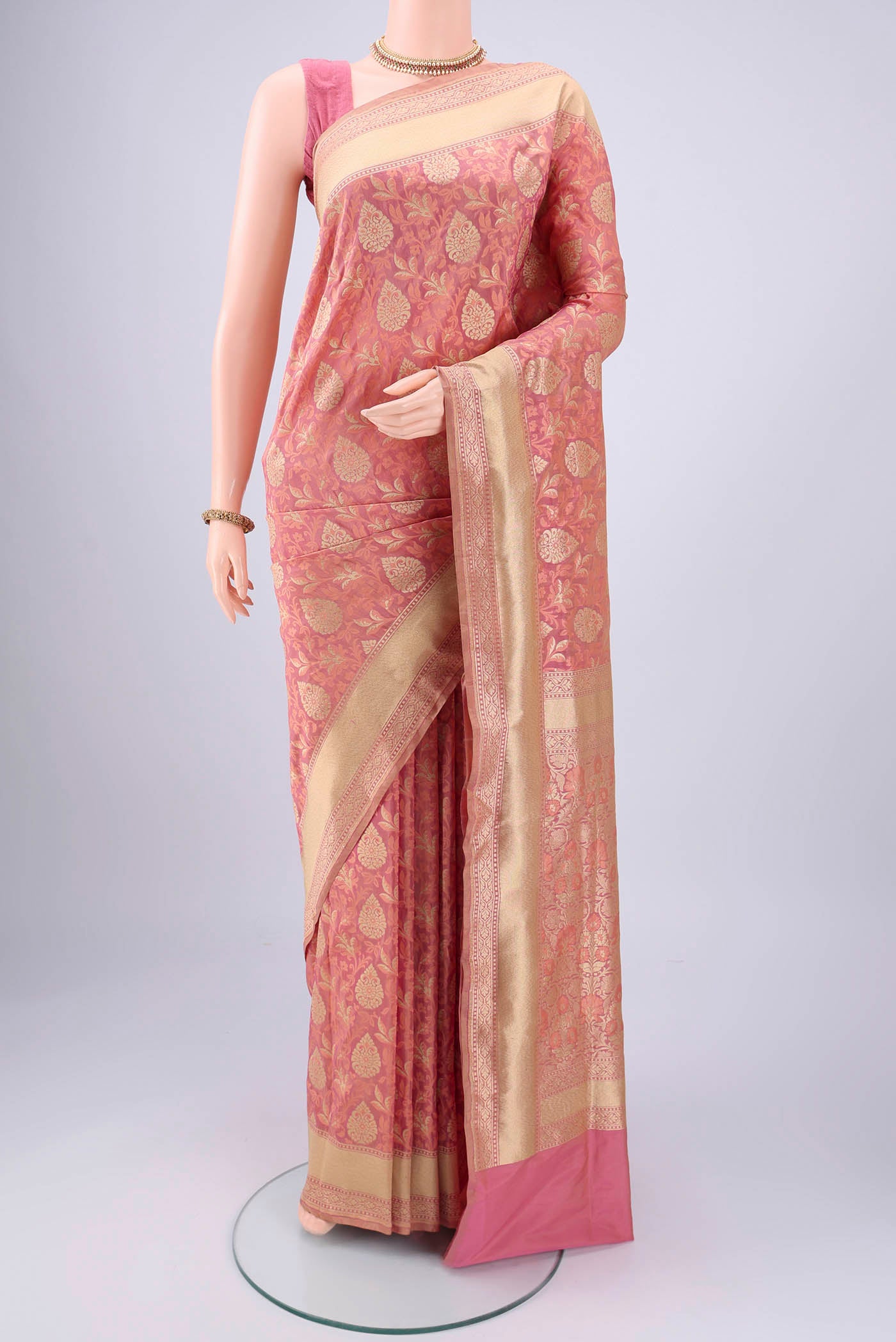 Rose Gold Banarasi Silk Saree with Jacquard With Zari Butta on the body and Zari Border.  displayed on a mannequin