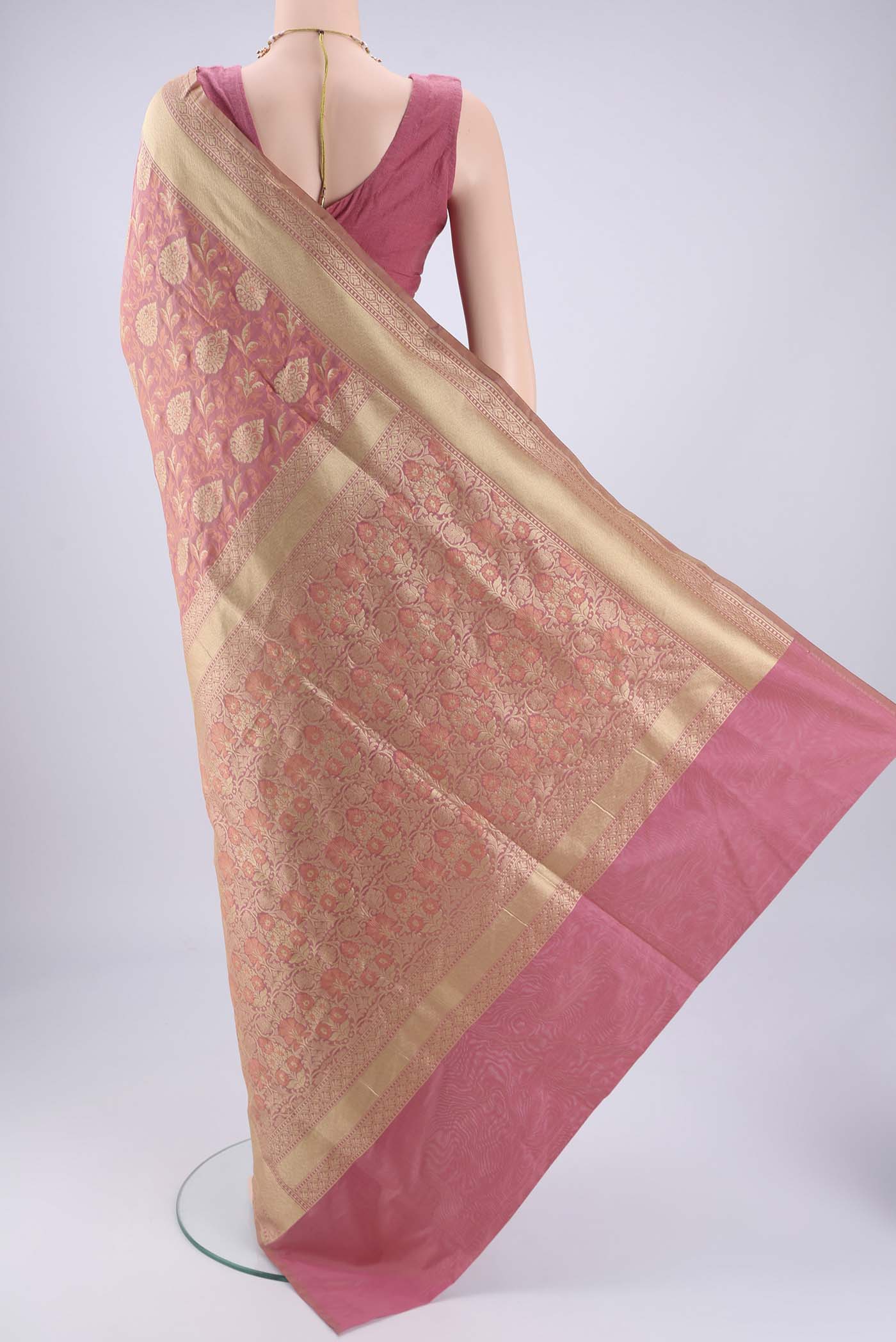 Flat view of Rose Gold Banarasi Silk Saree with Jacquard With Zari Butta on the body and Zari Border. 