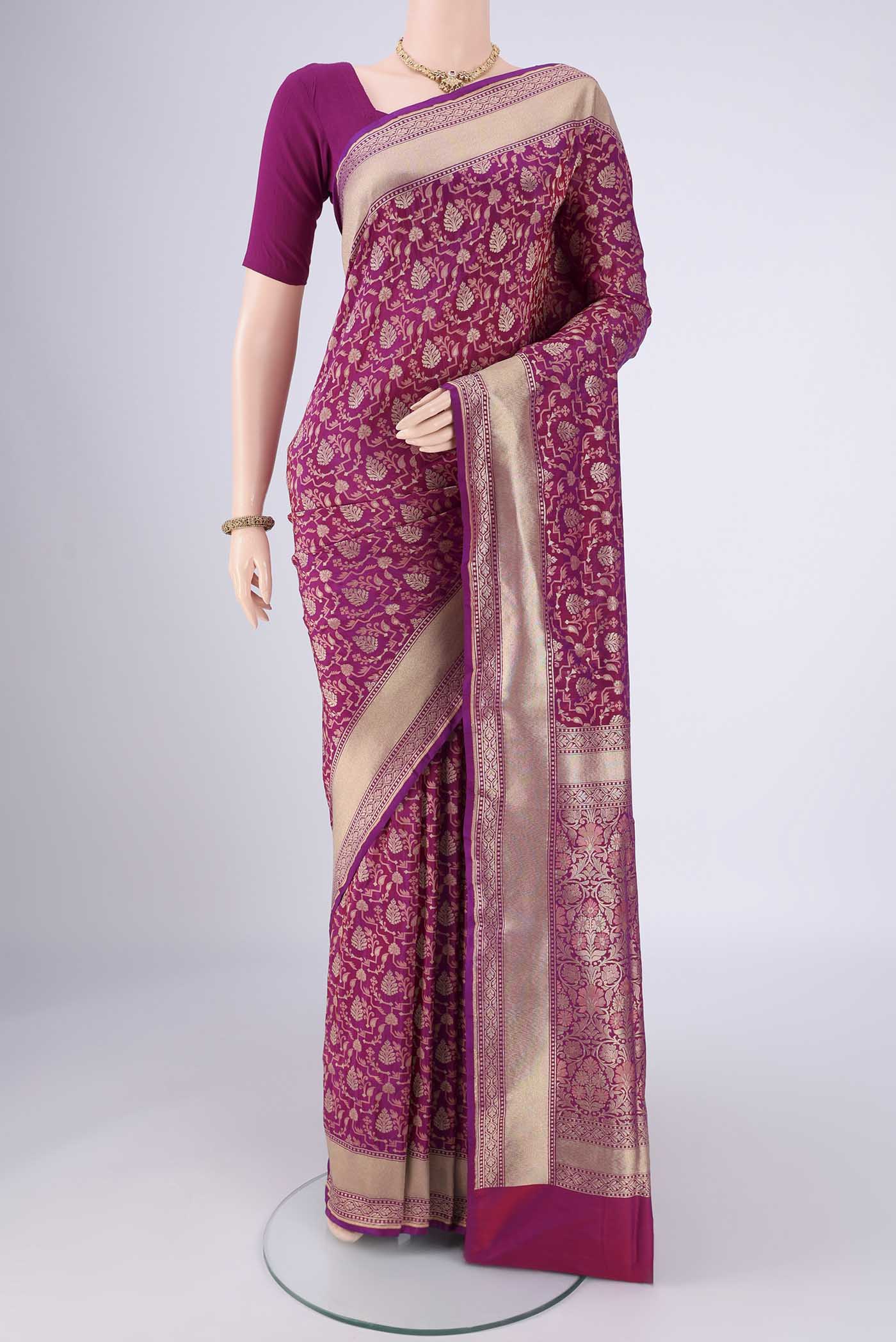 Magenta Banarasi Silk Saree with Jacquard With Zari Butta on the body and Zari Border.  displayed on a mannequin