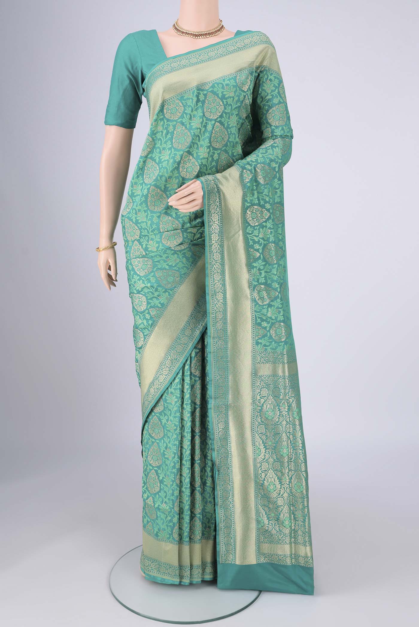 Turquoise Banarasi Silk Saree with Jacquard With Zari Butta on the body and Zari And Thread Border.  displayed on a mannequin