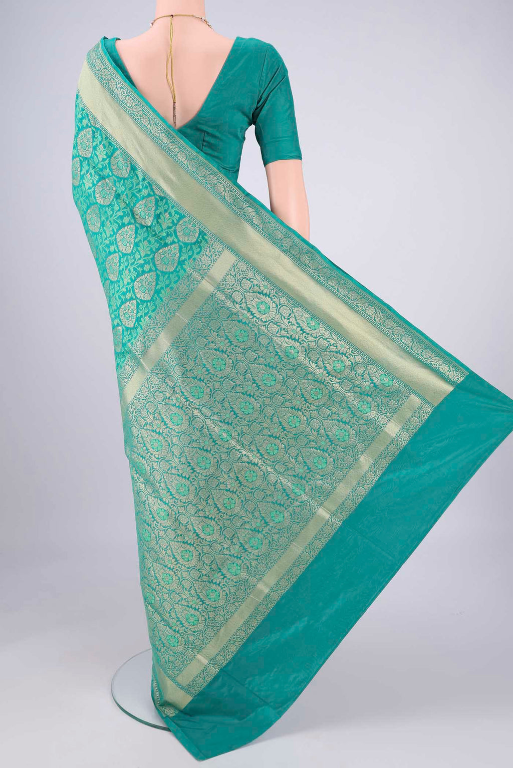 Flat view of Turquoise Banarasi Silk Saree with Jacquard With Zari Butta on the body and Zari And Thread Border. 
