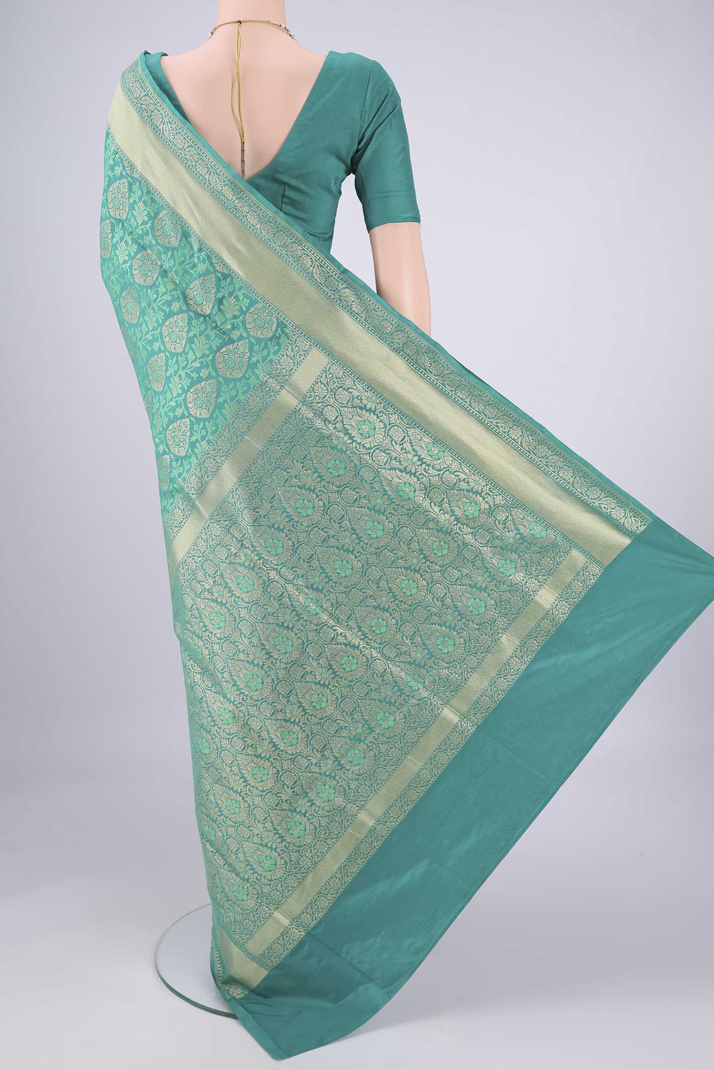 Flat view of Turquoise Banarasi Silk Saree with Jacquard With Zari Butta on the body and Zari And Thread Border. 