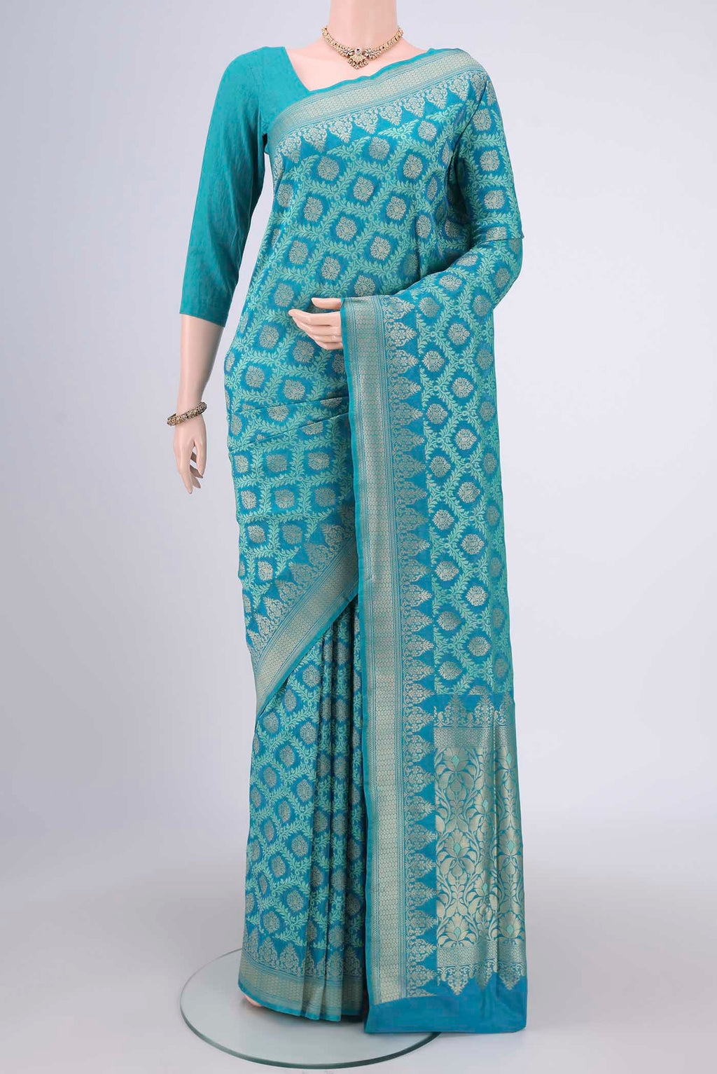 Sea Green Banarasi Silk Saree with Zari And Thread Butta on the body and Zari Border.  displayed on a mannequin