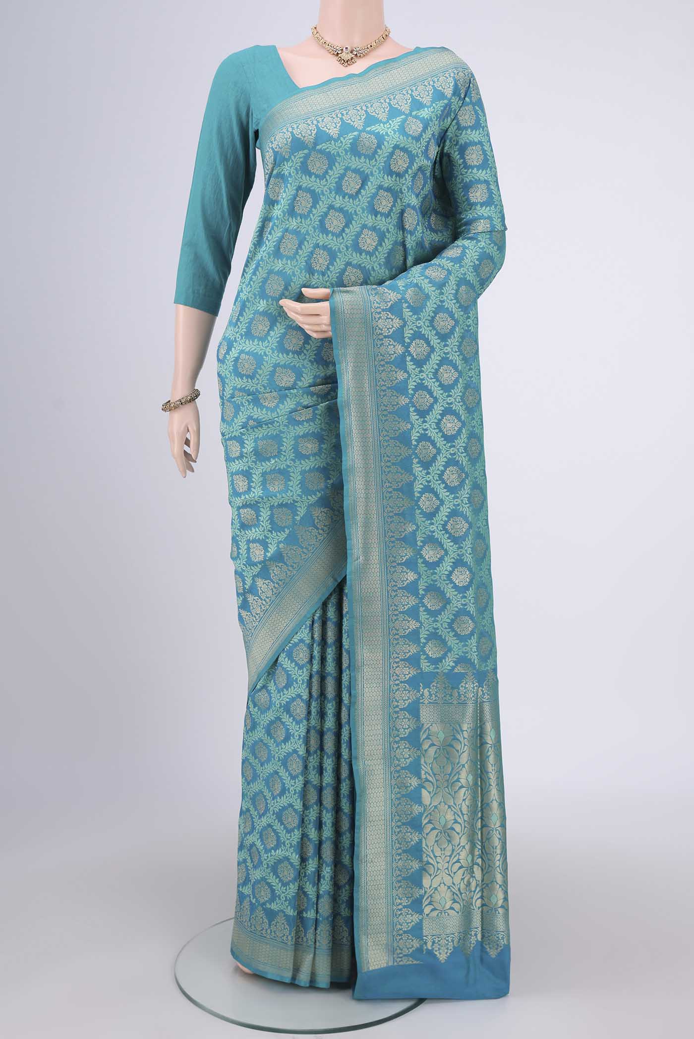 Sea Green Banarasi Silk Saree with Zari And Thread Butta on the body and Zari Border.  displayed on a mannequin