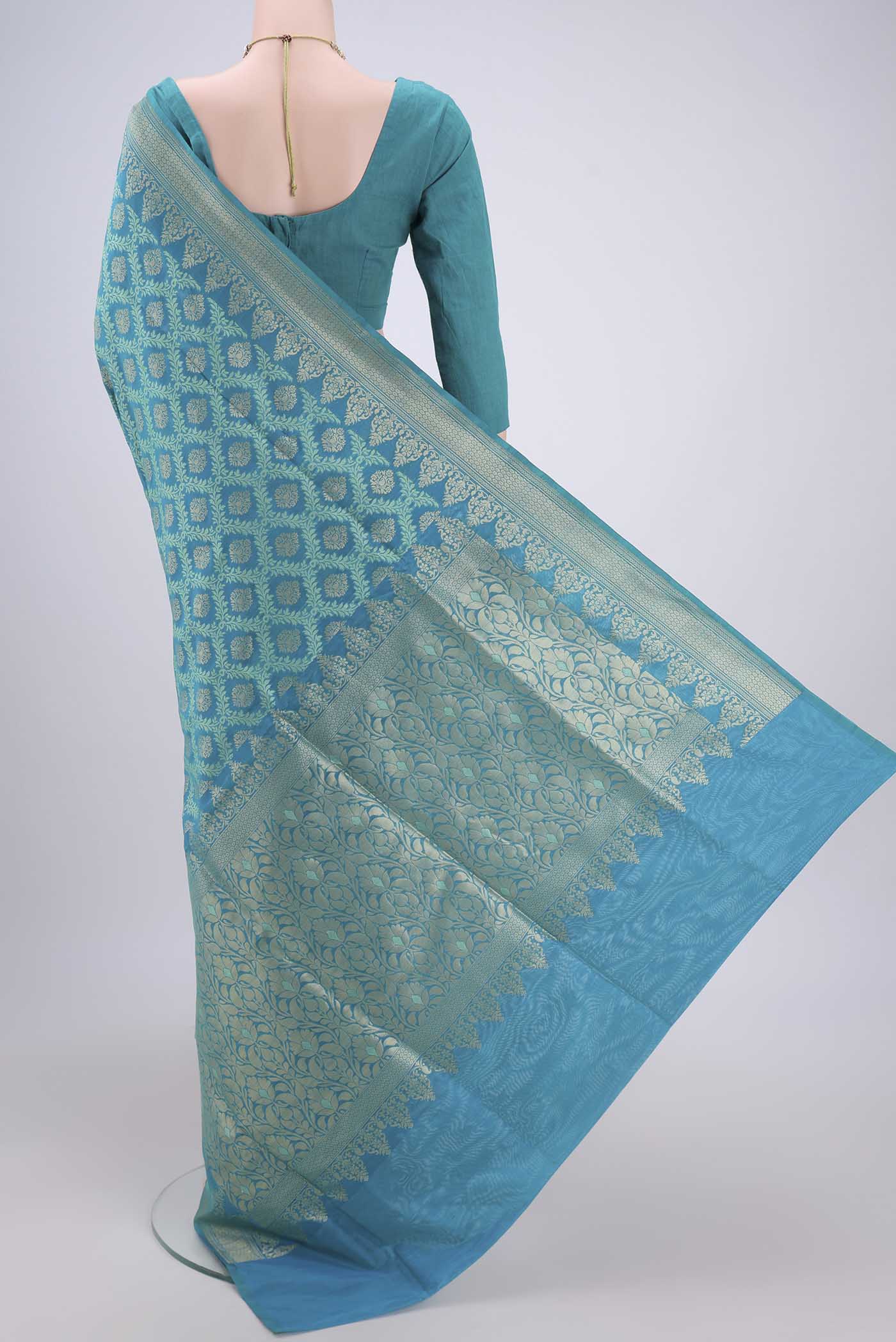 Flat view of Sea Green Banarasi Silk Saree with Zari And Thread Butta on the body and Zari Border. 