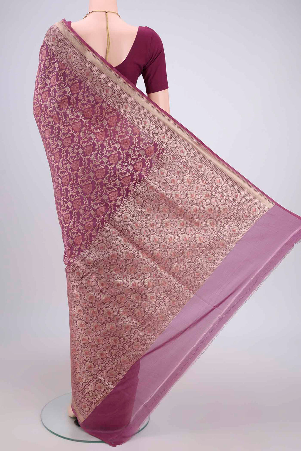 Flat view of Rose Gold Banarasi Silk Saree with Zari And Thread Butta on the body and Zari Border. 