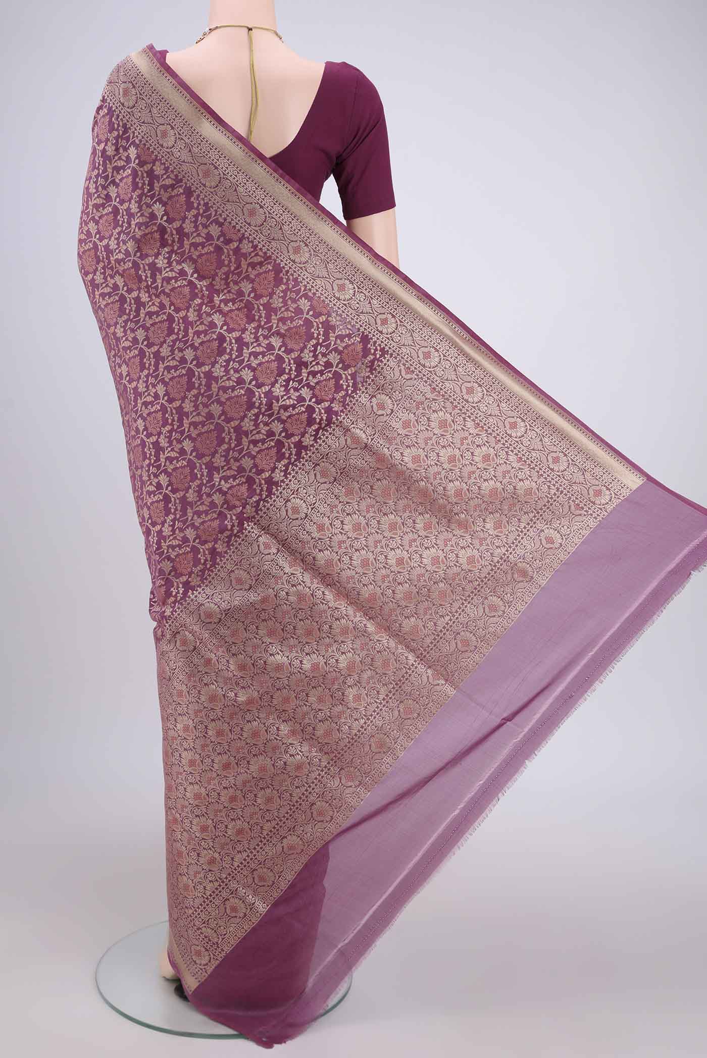 Flat view of Rose Gold Banarasi Silk Saree with Zari And Thread Butta on the body and Zari Border. 
