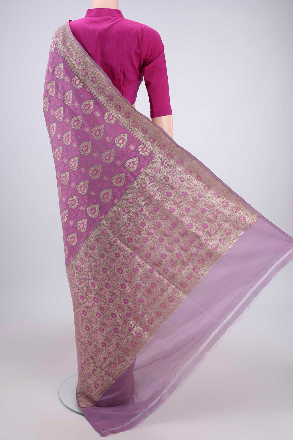 Flat view of Light Magenta Banarasi Silk Saree with Zari And Thread Butta on the body and Zari Border. 