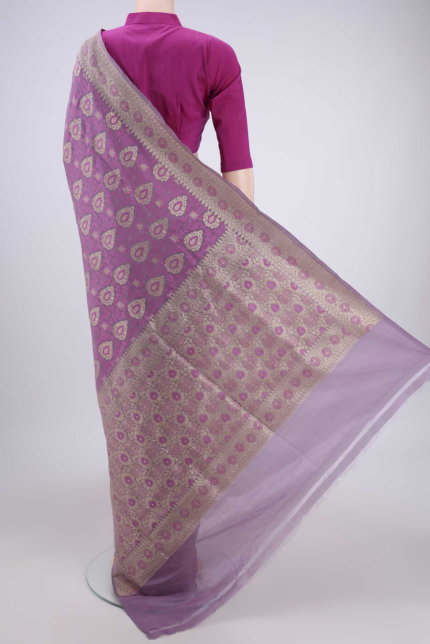 Flat view of Light Magenta Banarasi Silk Saree with Zari And Thread Butta on the body and Zari Border. 