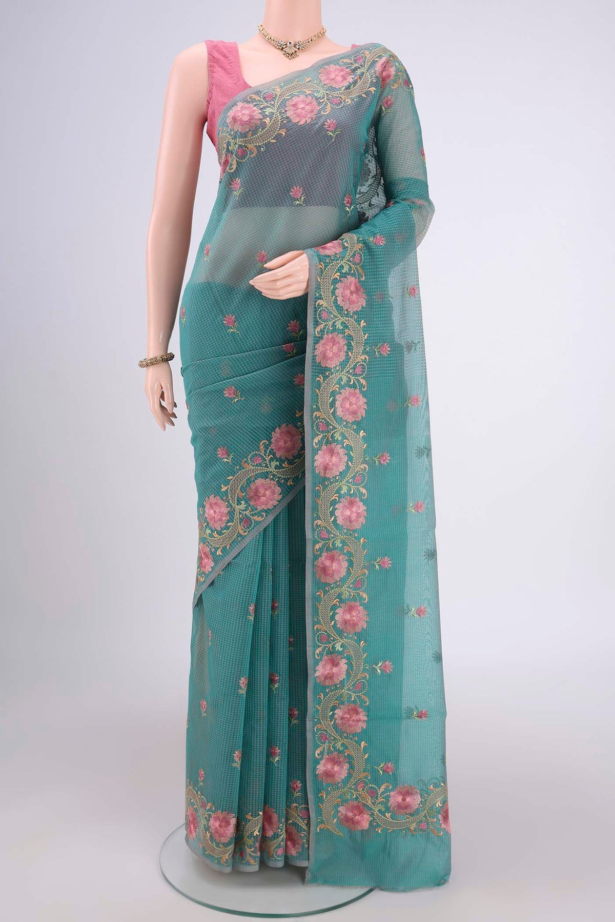 Sea Green Blended Kota Cotton Saree with Embroidery on the body and Embroidery Border.  displayed on a mannequin