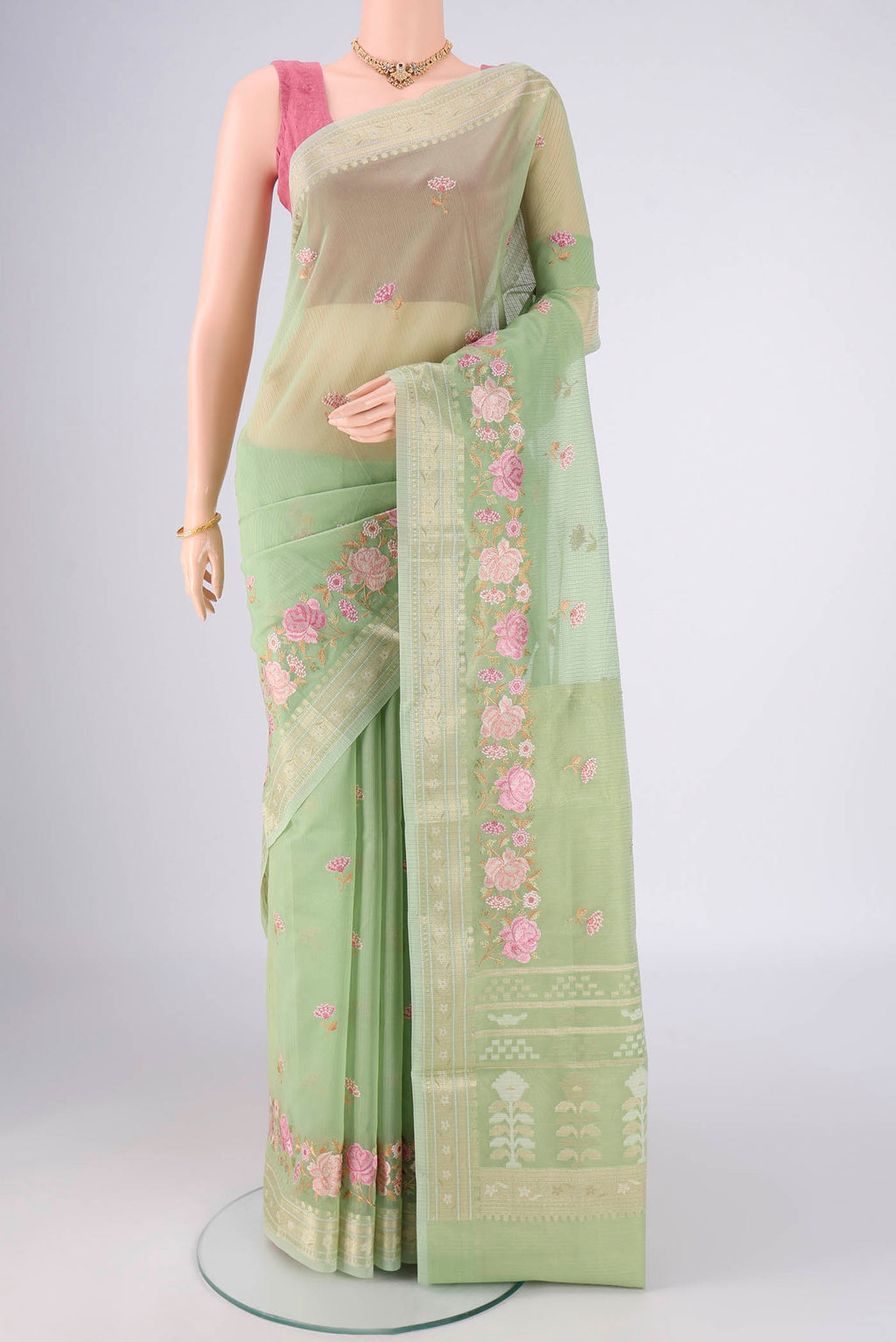 Light Green Blended Kota Cotton Saree with Embroidery on the body and Zari Border.  displayed on a mannequin