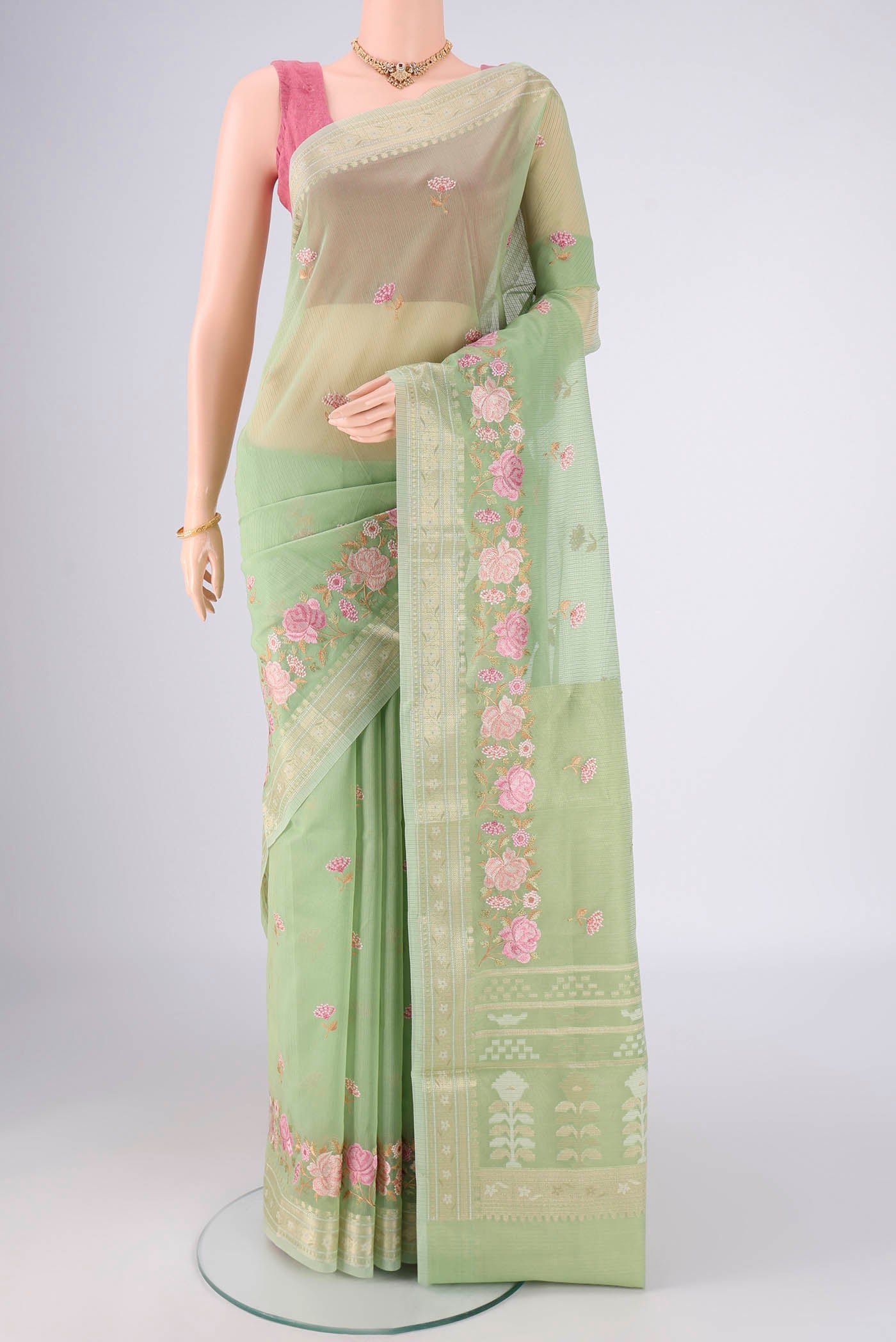 Light Green Blended Kota Cotton Saree with Embroidery on the body and Zari Border.  displayed on a mannequin