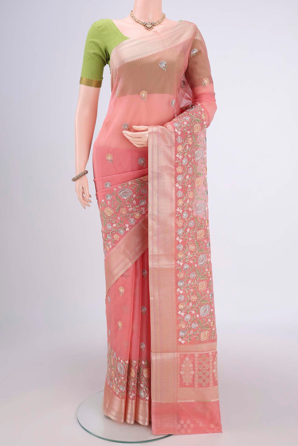 Peach Blended Kota Cotton Saree with Embroidery on the body and Zari Border.  displayed on a mannequin