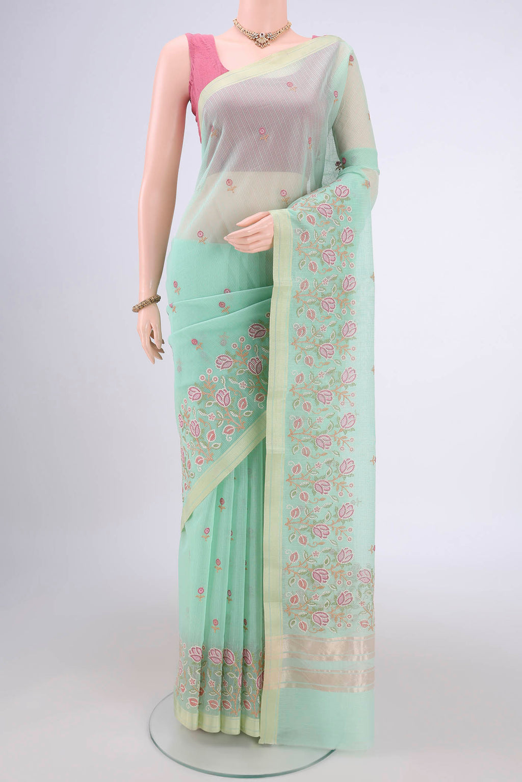 Mint Green Blended Kota Cotton Saree with Embroidery on the body and Zari Border.  displayed on a mannequin