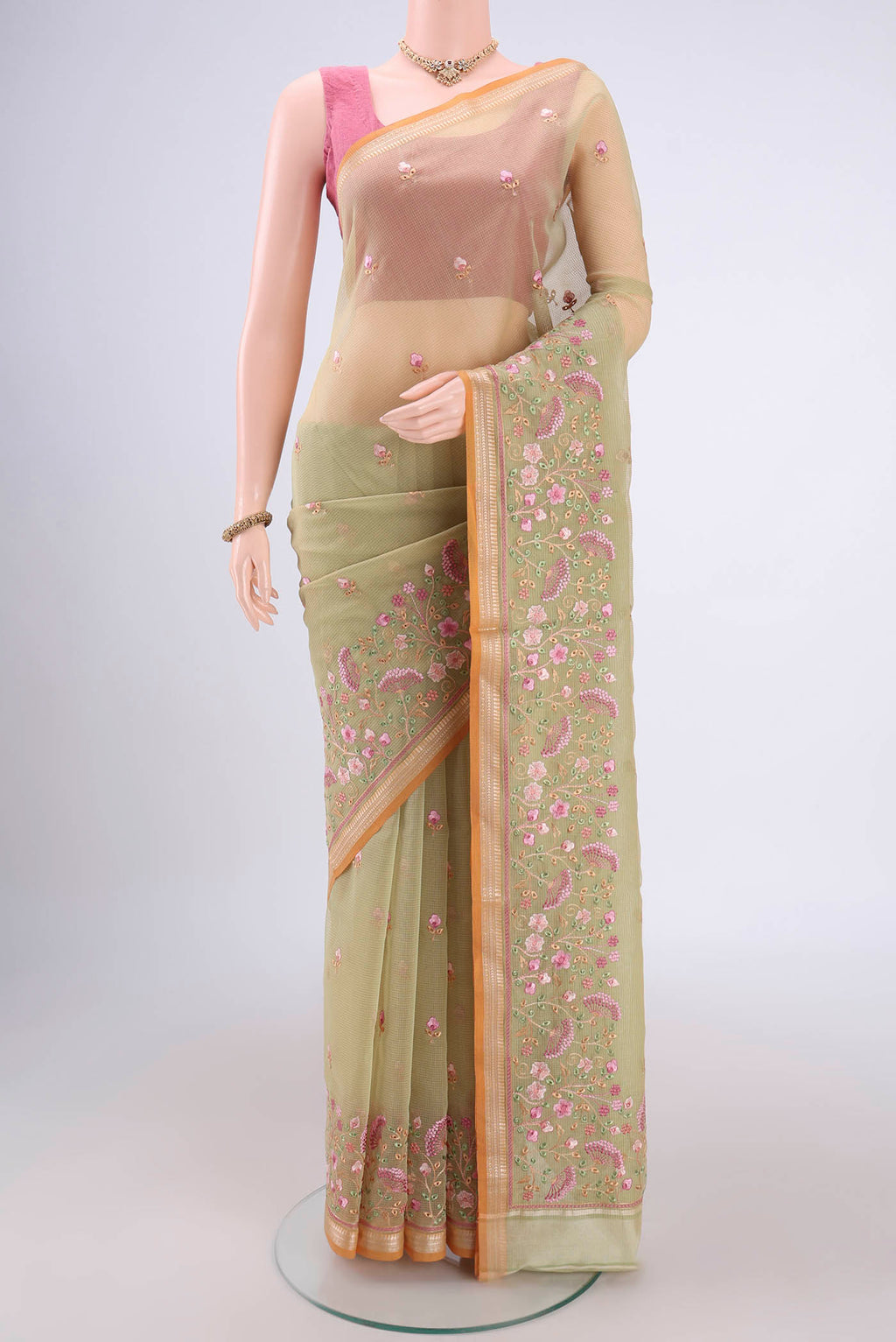 Light Green Blended Kota Cotton Saree with Embroidery on the body and Zari Border.  displayed on a mannequin