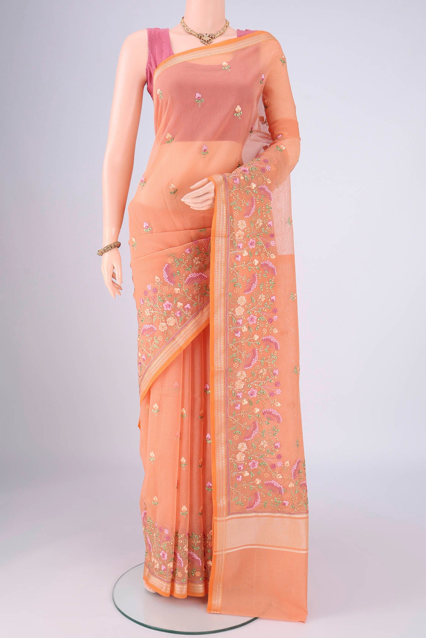 Orange Blended Kota Cotton Saree with Embroidery on the body and Thread Border.  displayed on a mannequin