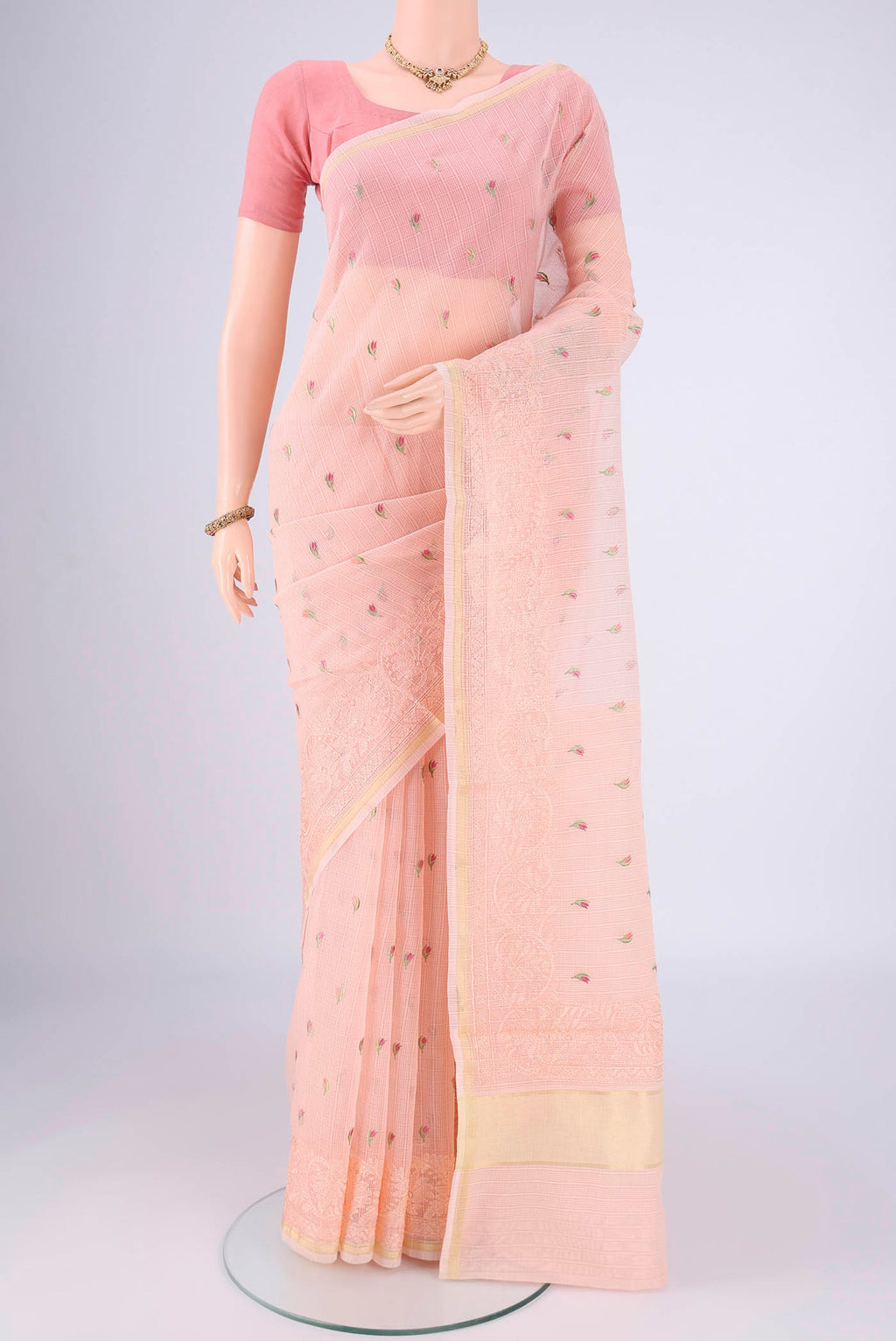 Peach Blended Kota Cotton Saree with Embroidery on the body and Checks Border.  displayed on a mannequin