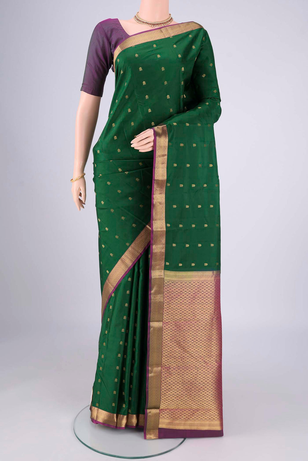 Purple Kanjivaram Silk Saree with Zari Butta on the body and Zari Border.  displayed on a mannequin