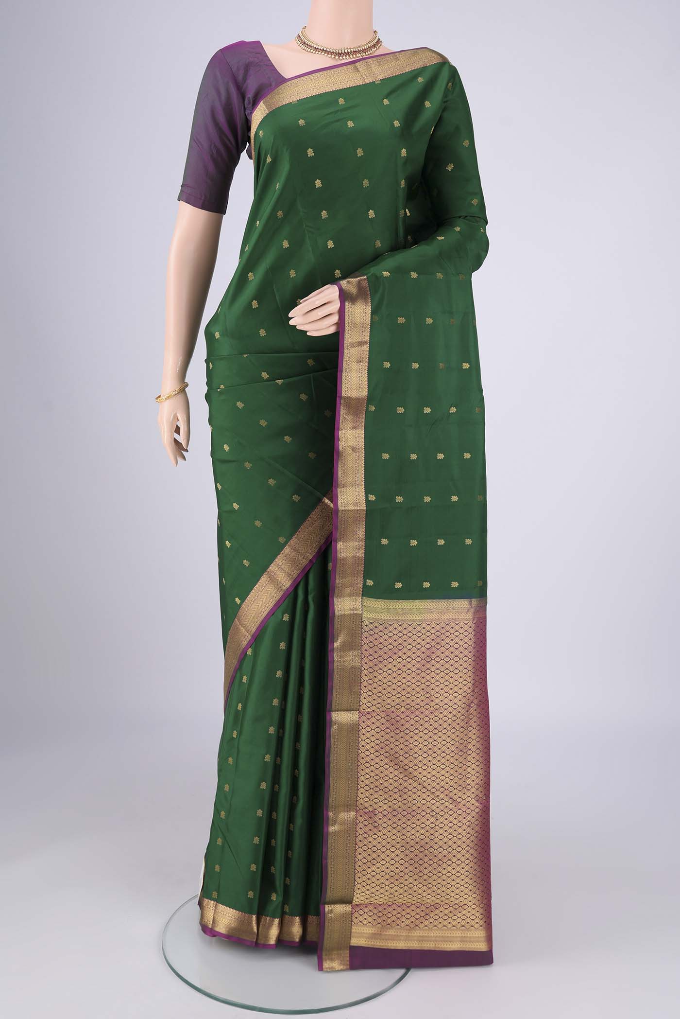 Purple Kanjivaram Silk Saree with Zari Butta on the body and Zari Border.  displayed on a mannequin